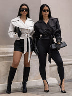 White and black cropped trench jackets with wide collars and tied waist belts