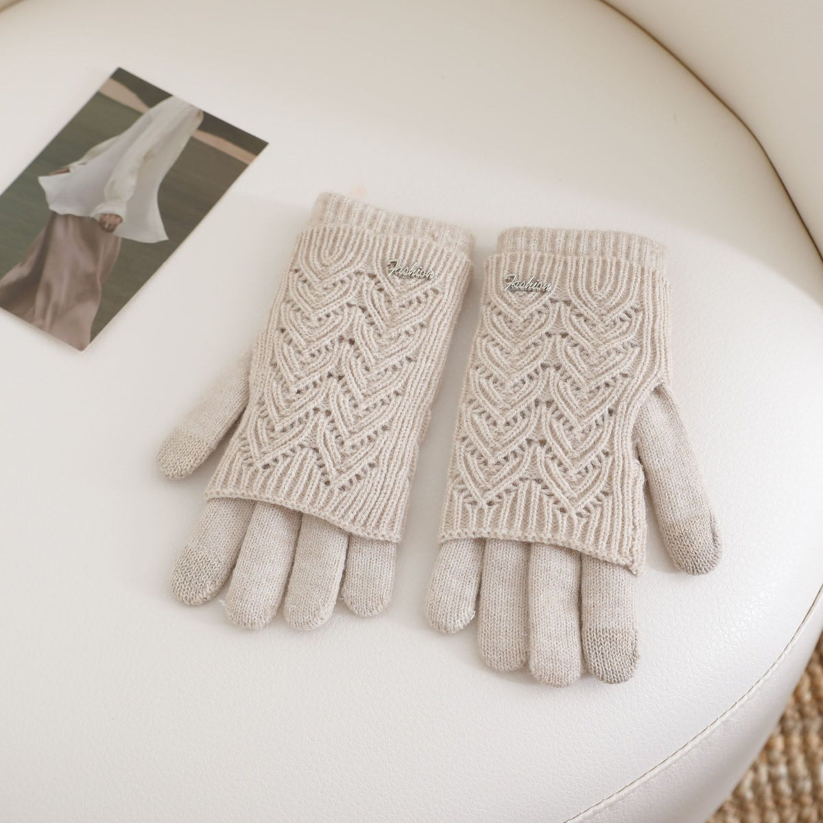 Women’s beige fingerless knit gloves with ribbed cuffs and textured wave pattern
