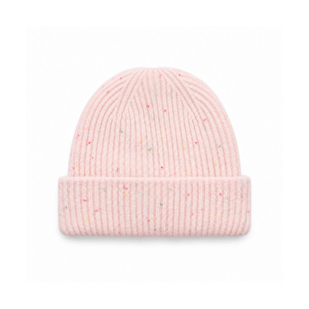 Speckled light pink rib-knit beanie with a wide folded cuff.