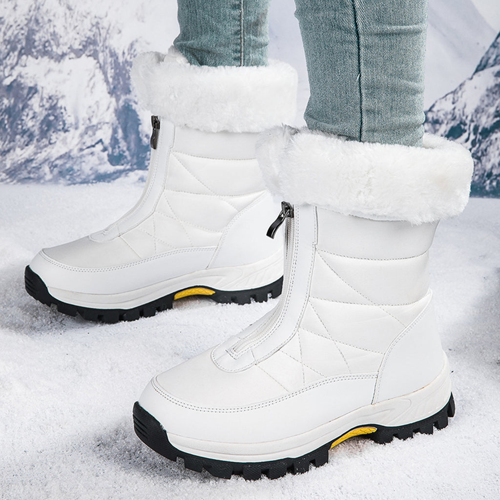 White mid-calf zip-up snow boots with quilted panels, faux fur cuff, lug sole.