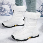 White mid-calf zip-up snow boots with quilted panels, faux fur cuff, lug sole.