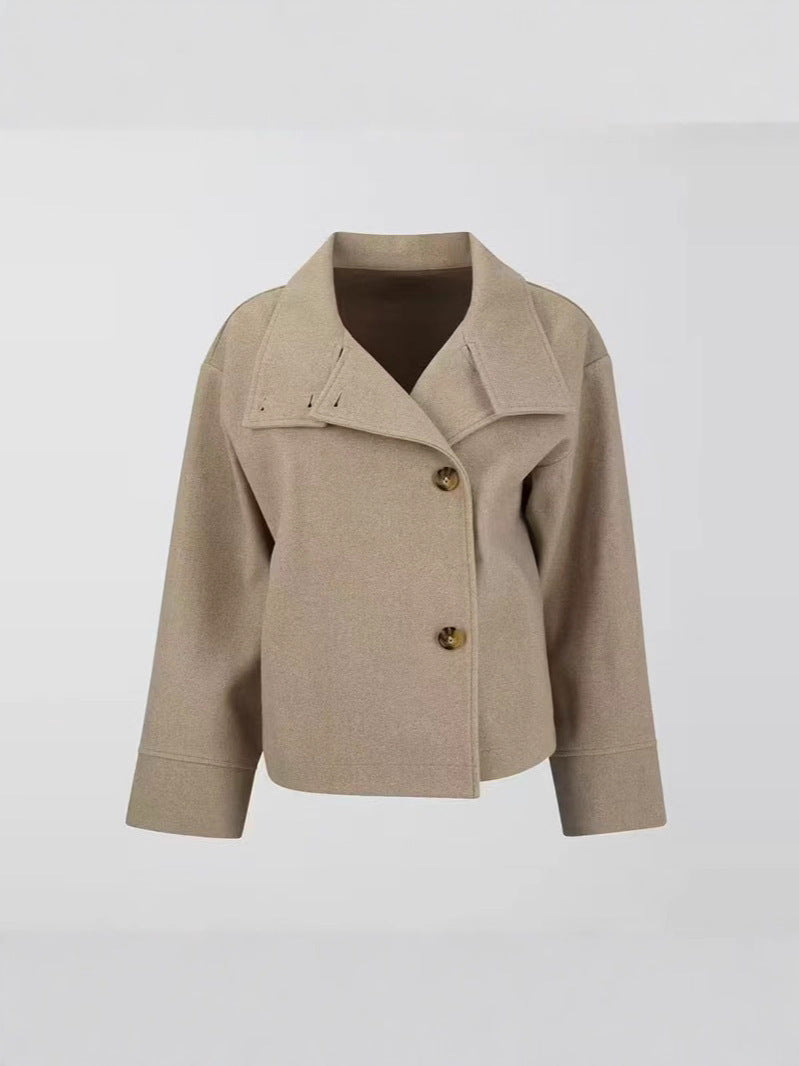 Cropped stand-collar wool jacket in light beige with button front and long sleeves on hanger