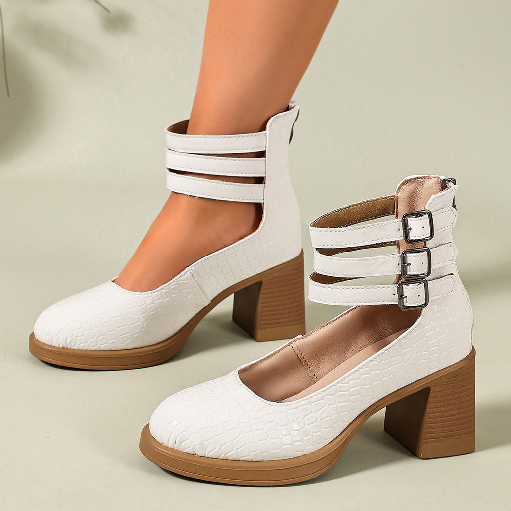 White croc-embossed platform ankle strap pumps with block heels and triple buckle cuff