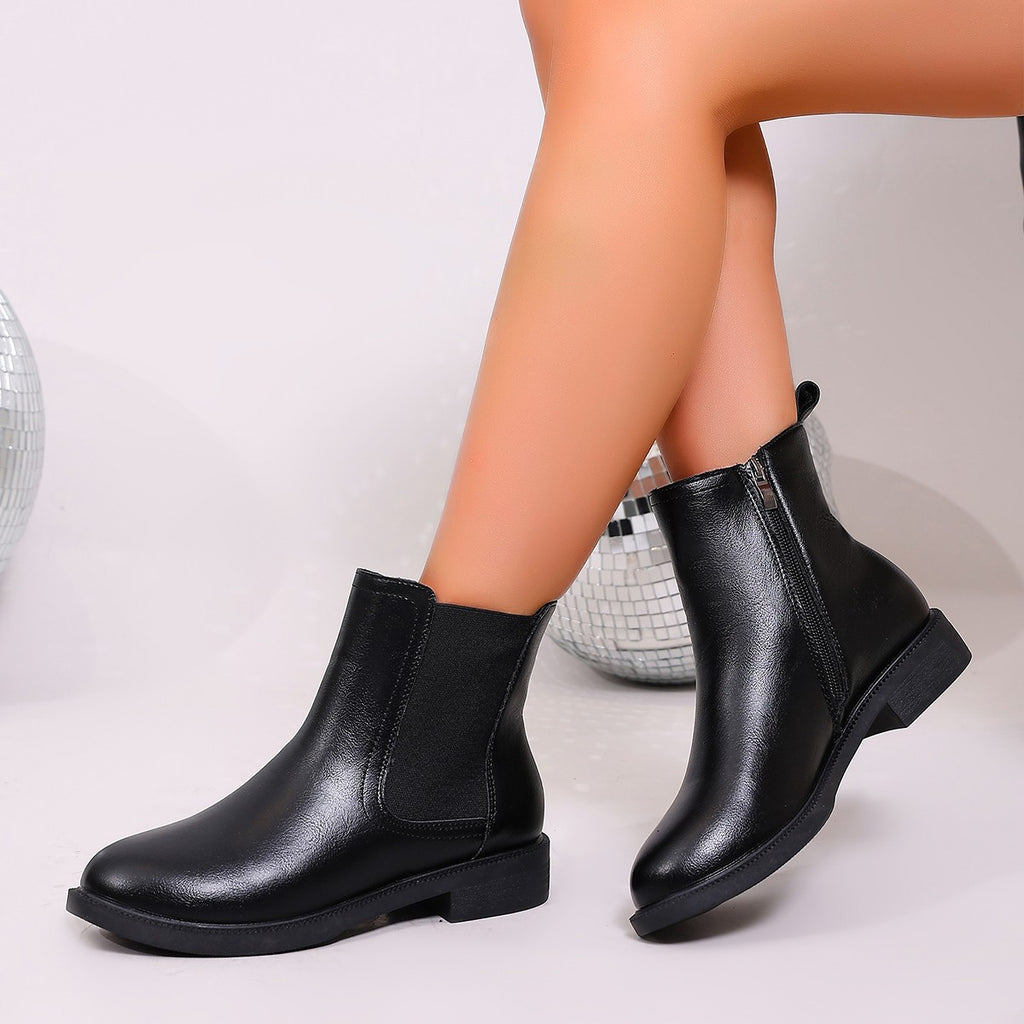 Black chelsea ankle boots with elastic panels and low block heel; side zip entry
