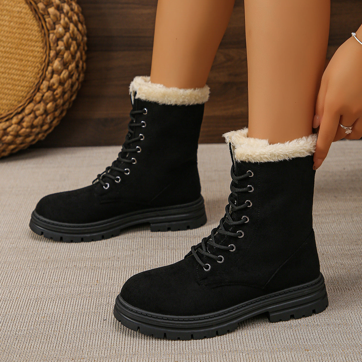 Black faux suede lace-up combat boots with faux fur fold-over cuff and chunky lug sole
