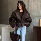 Brown belted moto jacket with wide lapels and front zipper, oversized sleeves