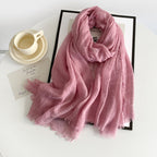 Pink cotton gauze scarf with crinkle texture and frayed fringe ends, long wrap