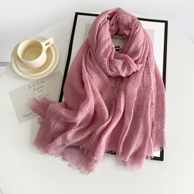 Pink cotton gauze scarf with crinkle texture and frayed fringe ends, long wrap