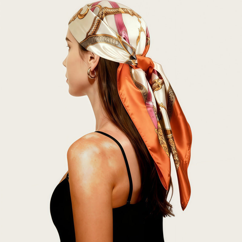 Orange satin head scarf with gold print, large square wrap tied at the side