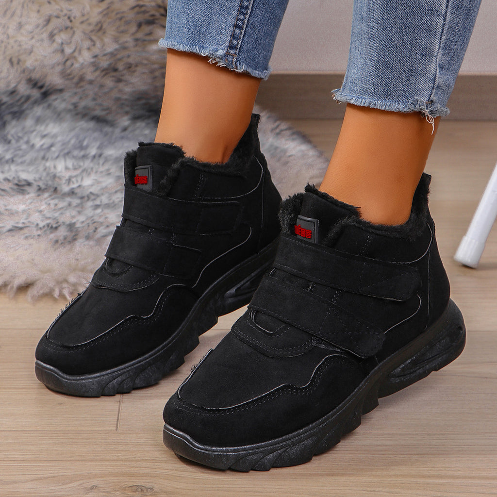 Black high-top sneakers with fleece lining, hook-and-loop strap, and thick sole