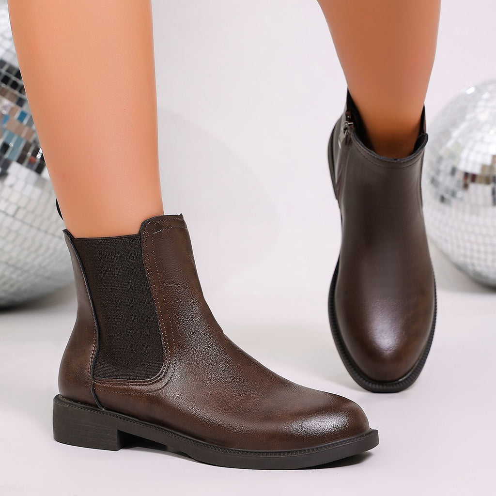 Brown chelsea ankle boots with elastic gore and low block heel; side zip detail