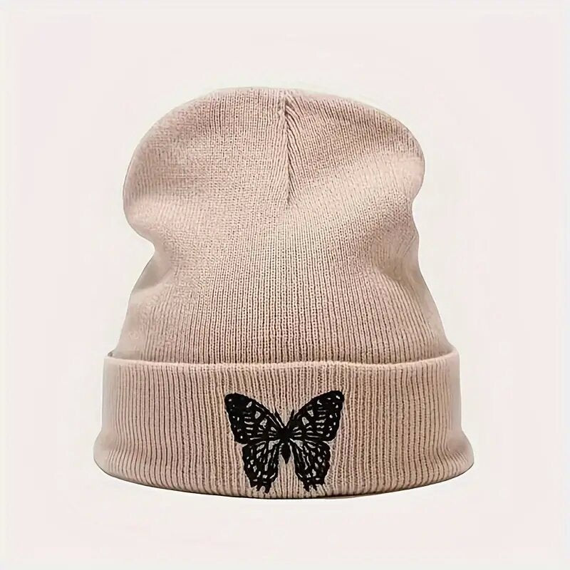 Beige knit beanie with black butterfly embroidery on front brim