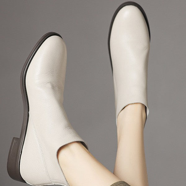 Off-white leather ankle boots with low block heel and back zip, front and side