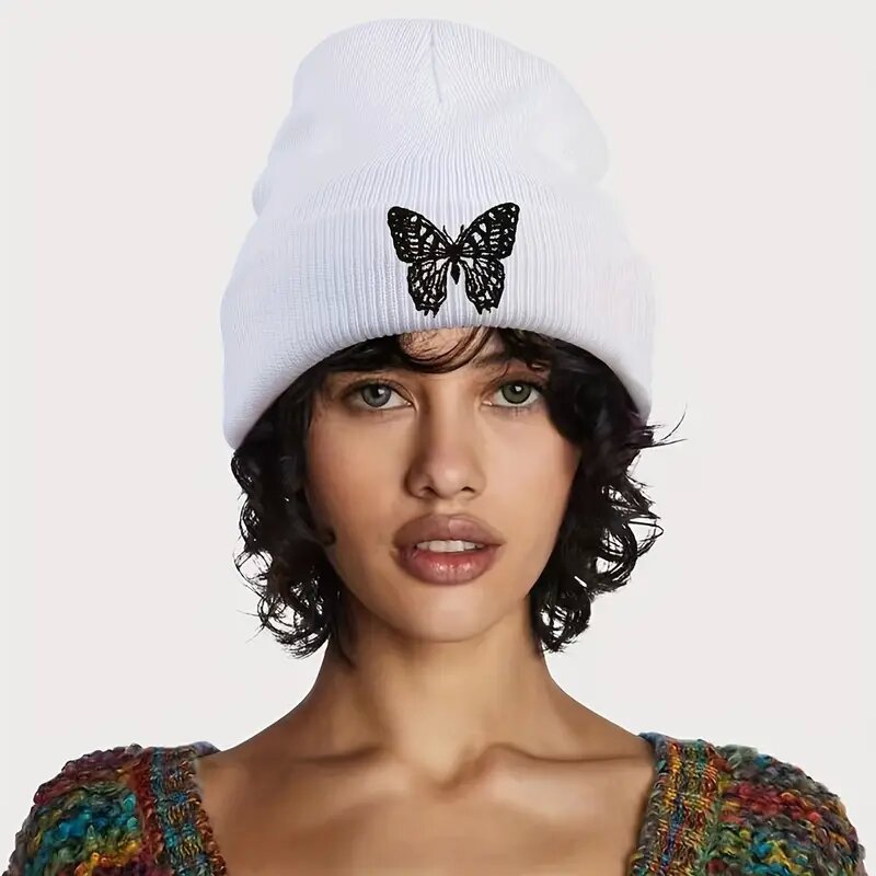 White ribbed knit beanie with black butterfly applique on front