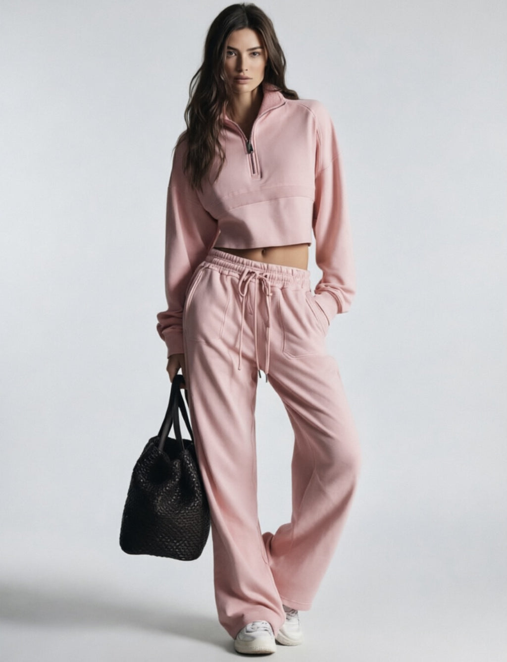 Pink women's sweatsuit with cropped half-zip sweatshirt and wide-leg drawstring pants