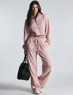 Pink women's sweatsuit with cropped half-zip sweatshirt and wide-leg drawstring pants