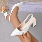 White croc-embossed slingback pumps with pointed toe and block heel.