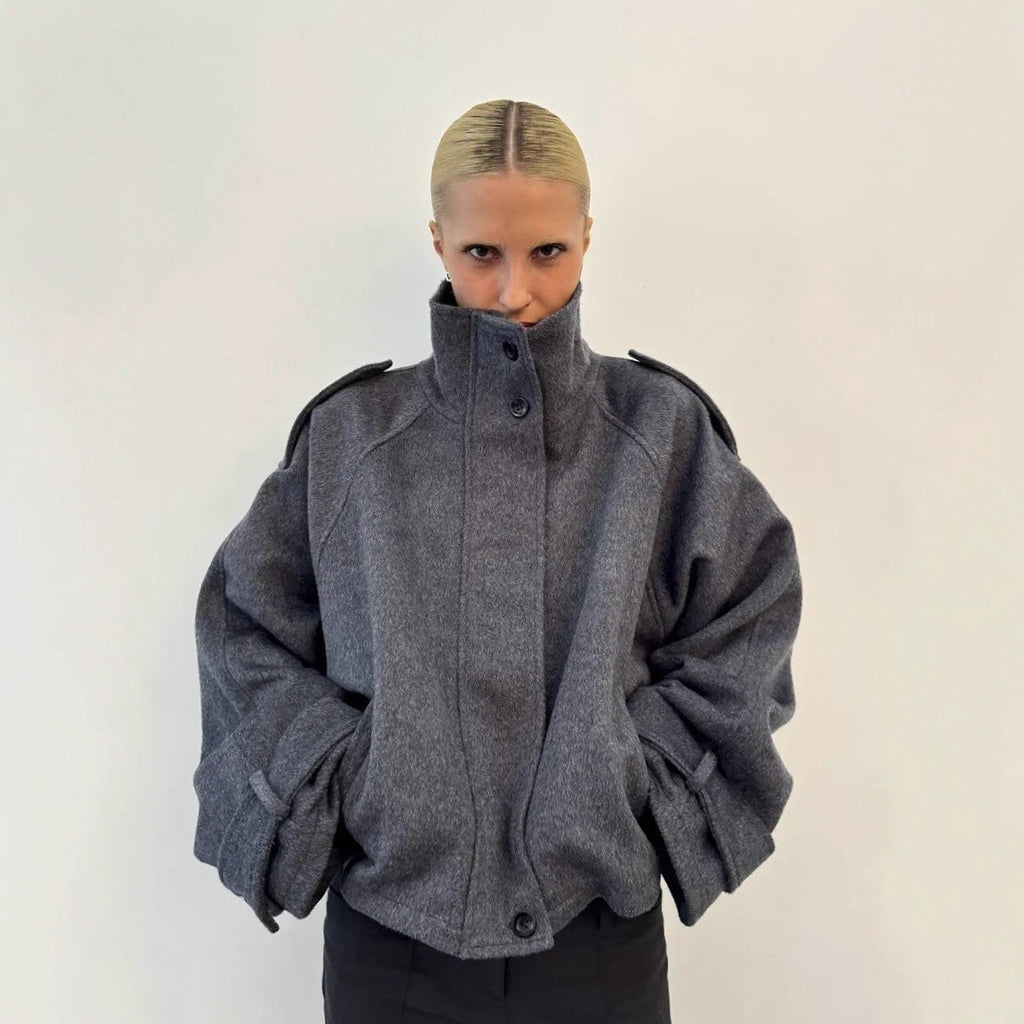 Dark gray cropped wool jacket, funnel neck, button front, epaulettes, cuff tabs.