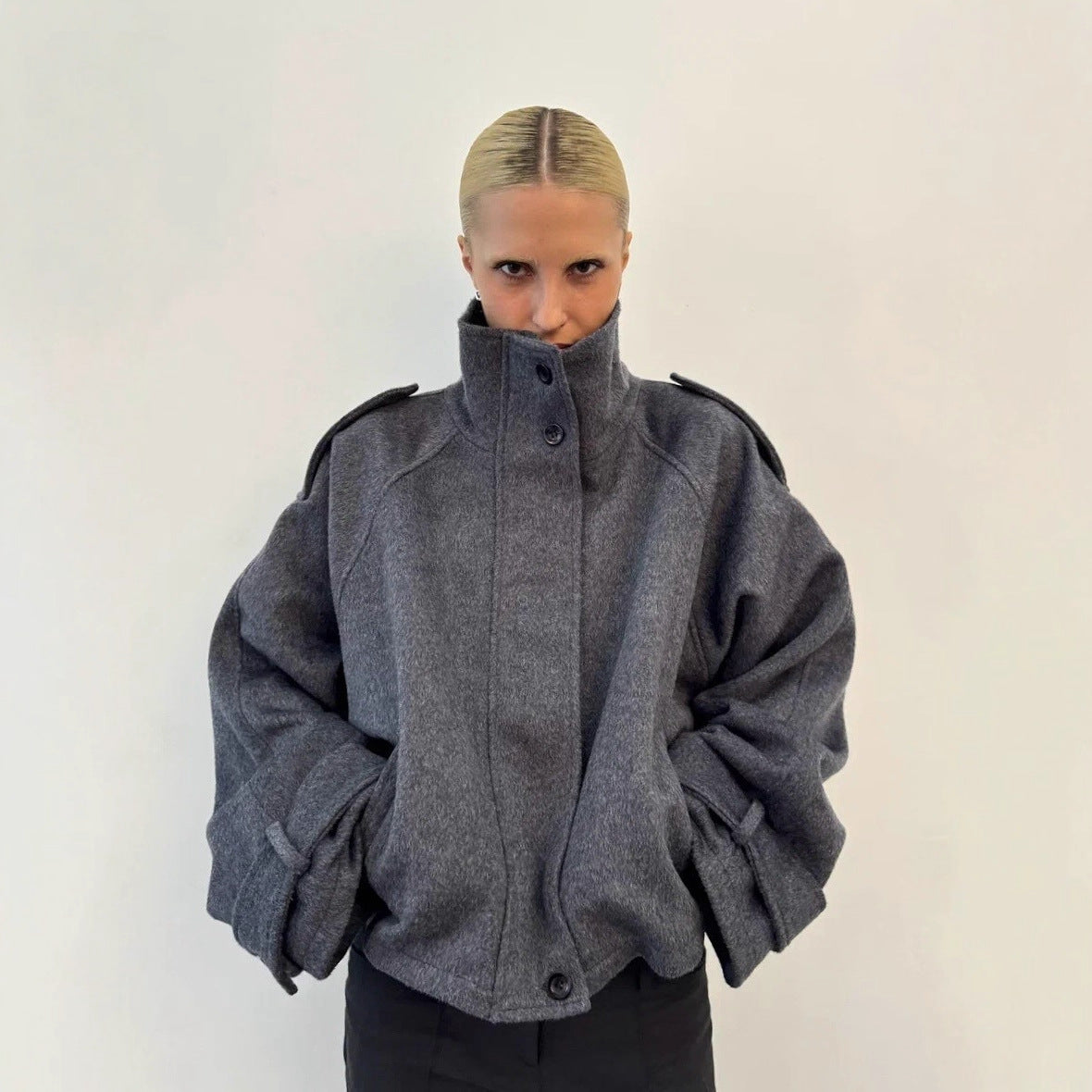 Dark gray cropped wool jacket, funnel neck, button front, epaulettes, cuff tabs.