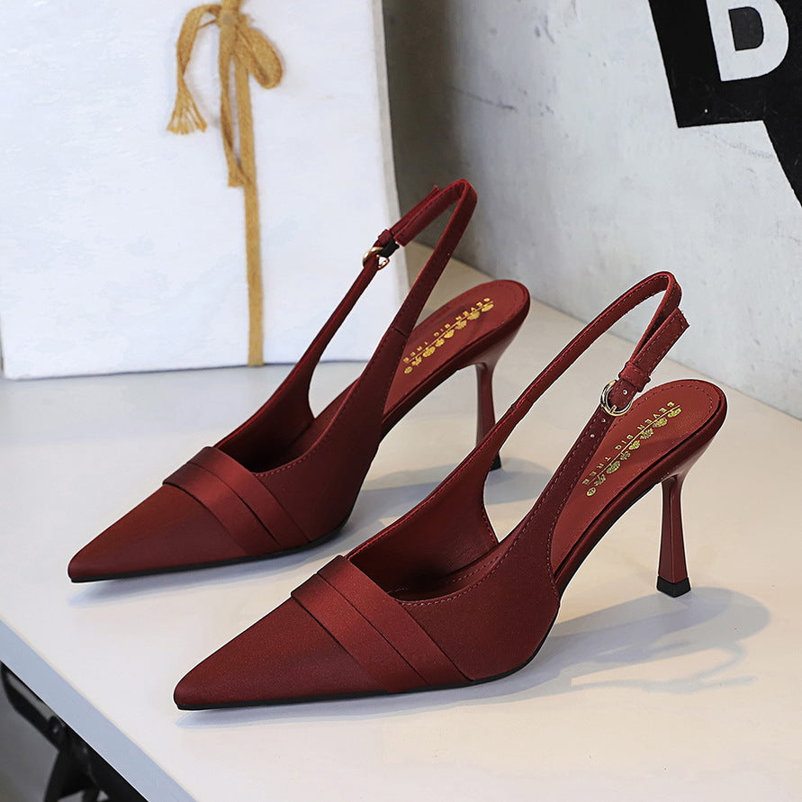 Burgundy satin slingback heels with pointed toe, stiletto heel, and folded vamp band.