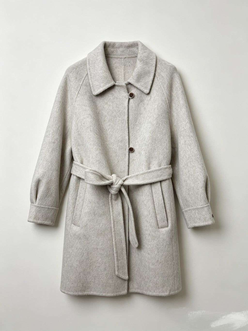 Light gray wool coat with a notched collar, button front, raglan sleeves and tie belt