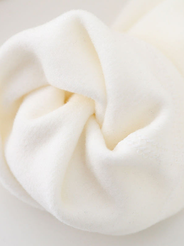 Close-up of off-white velvet fabric on a women’s hoodie