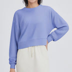 Light blue cropped crewneck sweatshirt with long sleeves and ribbed hem