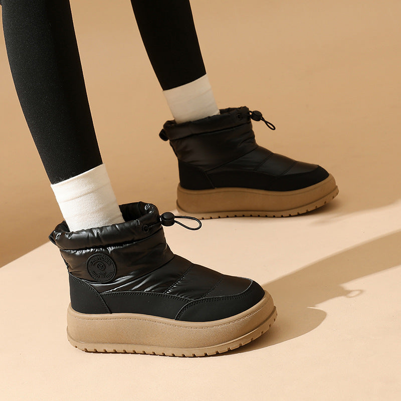 Black snow boots with drawstring collar and chunky tread sole