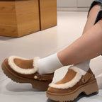 Camel-brown furry slippers with Velcro strap and thick sole, worn with white socks.