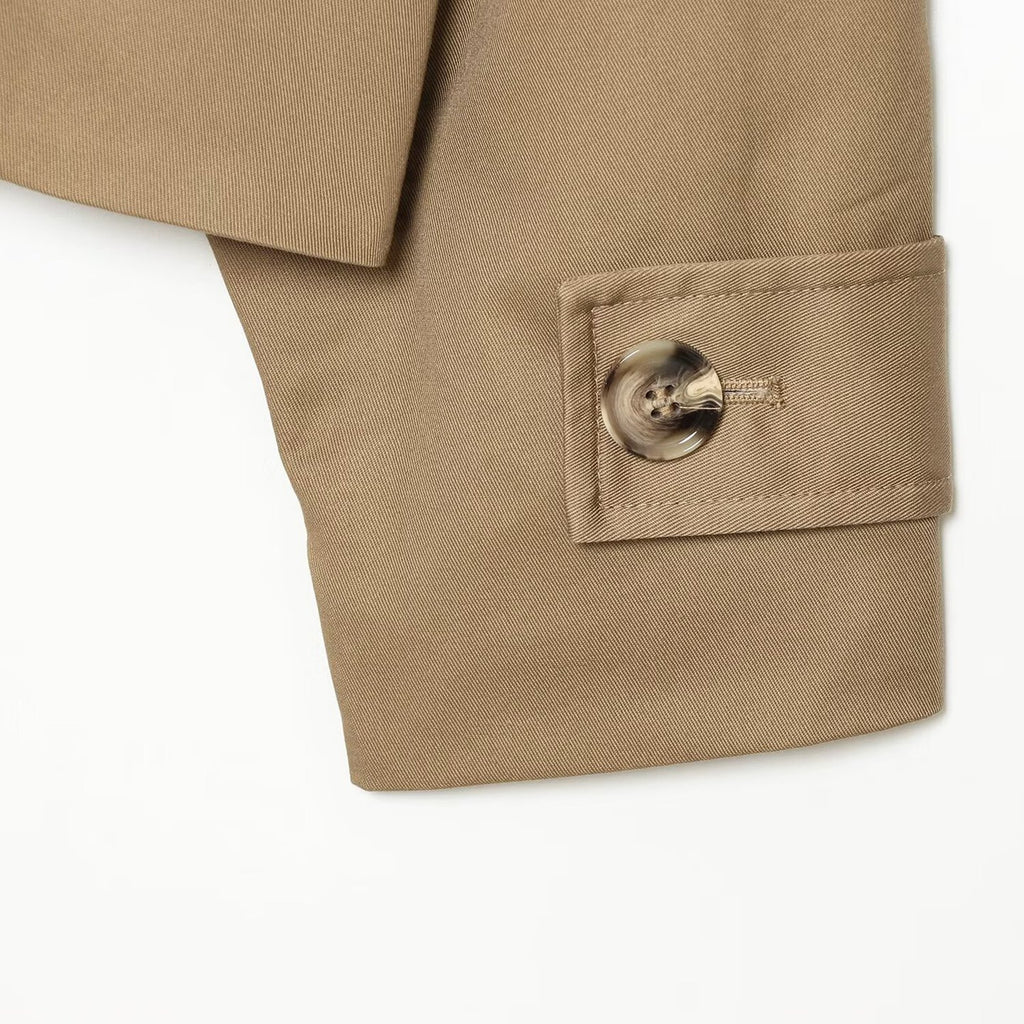 Khaki trench coat cuff with round button and neat stitching