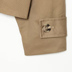 Khaki trench coat cuff with round button and neat stitching