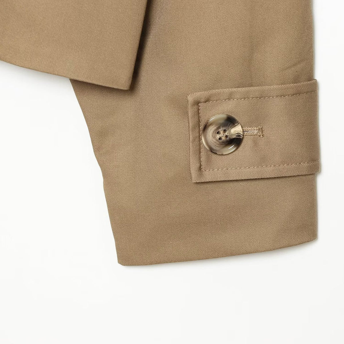 Khaki trench coat cuff with round button and neat stitching