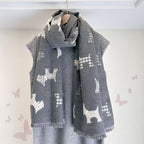 Gray dog-print scarf with fringed ends, wrapped around a mannequin