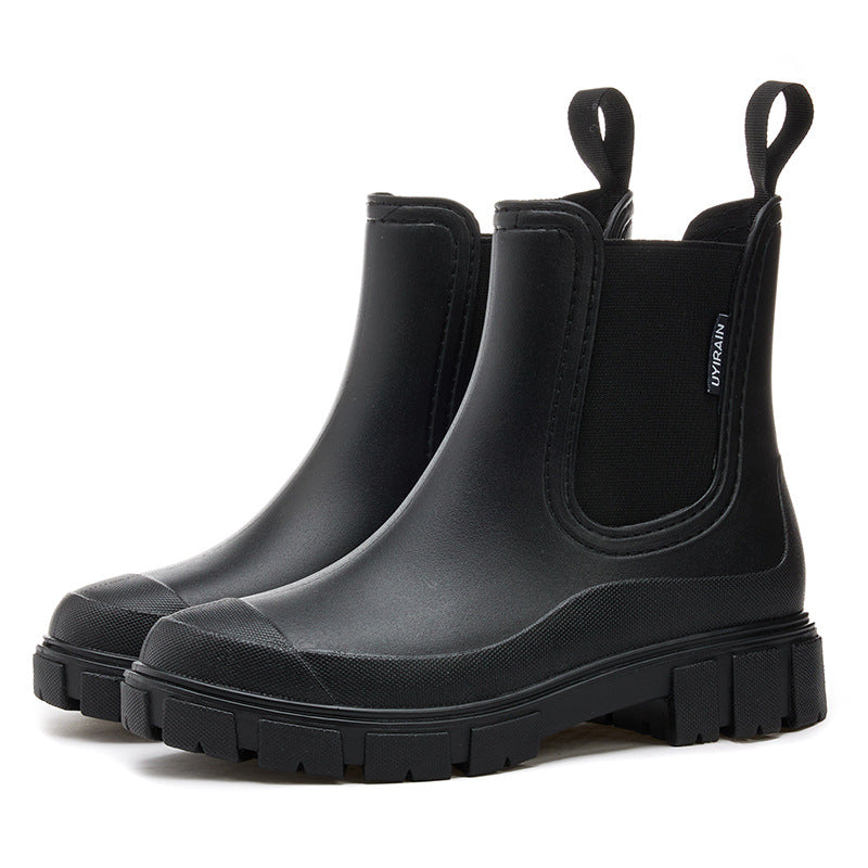 Chelsea rain boots in black matte rubber with side elastic panels and chunky lug sole.