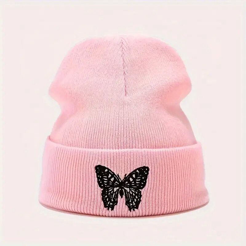 Pink knitted beanie with black butterfly applique on folded brim