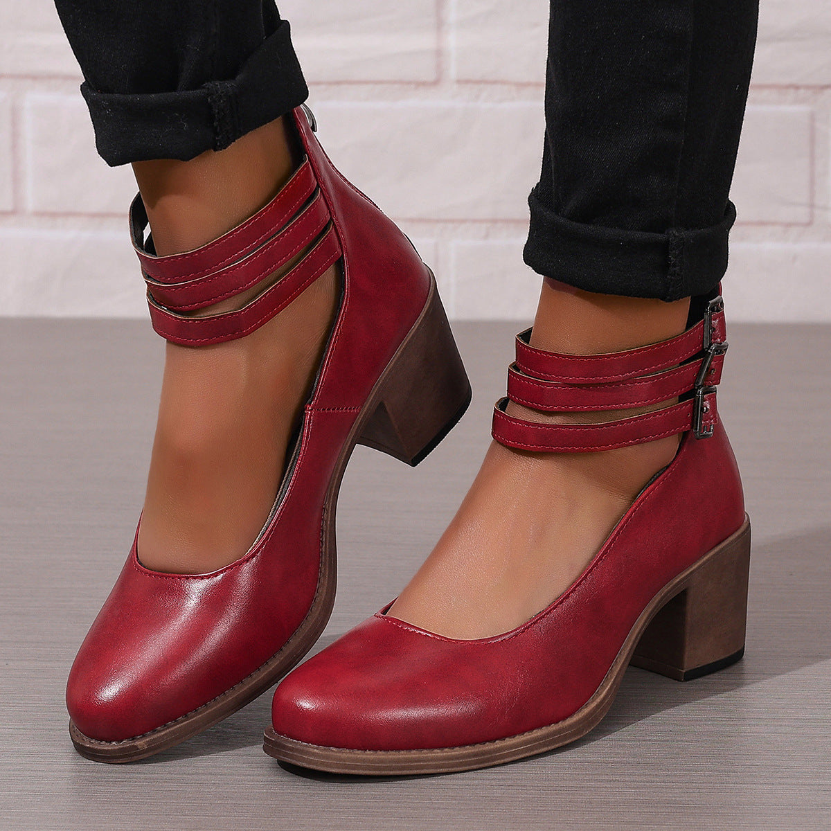 Burgundy closed-toe block heel pumps with ankle strap and side buckle