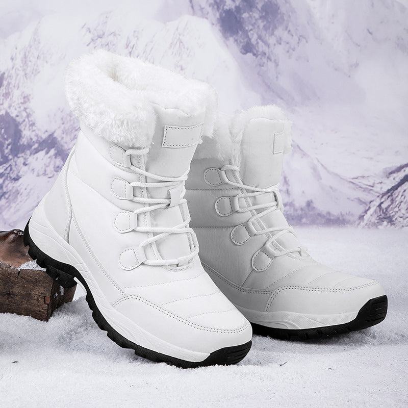Women’s white faux fur lined lace-up snow boots with padded high collar and lug sole.