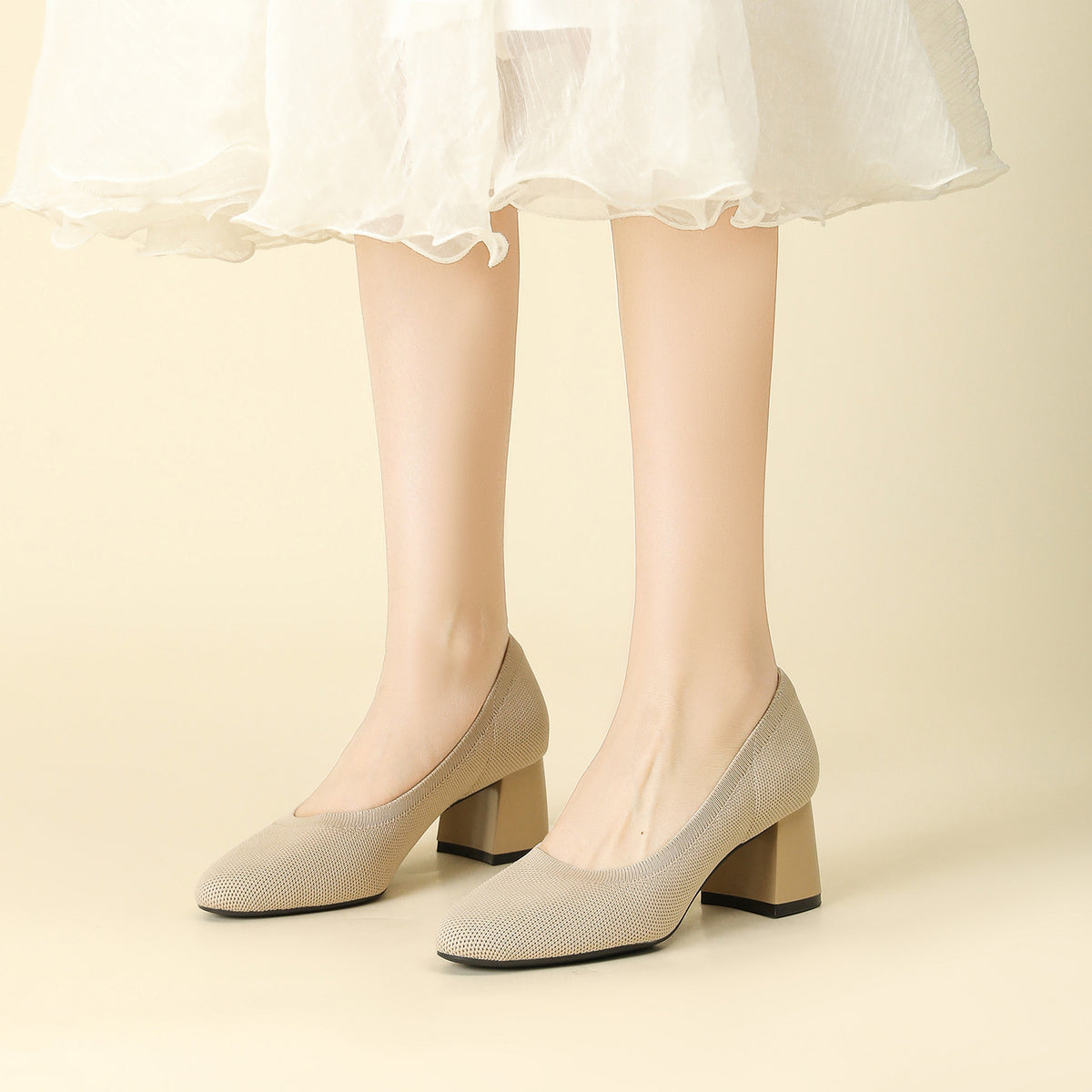 Beige knit block heel slip-on pumps with rounded toe and chunky mid heel