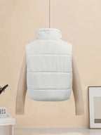 White sleeveless puffer vest with quilted horizontal baffles and stand collar.