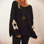 Women's black oversized knit sweater with flower motifs and drop shoulders