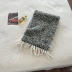 Chunky boucle knit scarf with fringe and a woven brand label