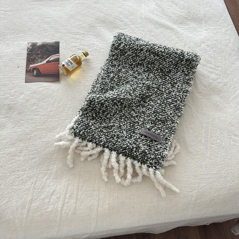 Chunky boucle knit scarf with fringe and a woven brand label