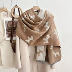 Camel dog-print blanket scarf with a contrasting reverse and fringed ends, draped over a coat