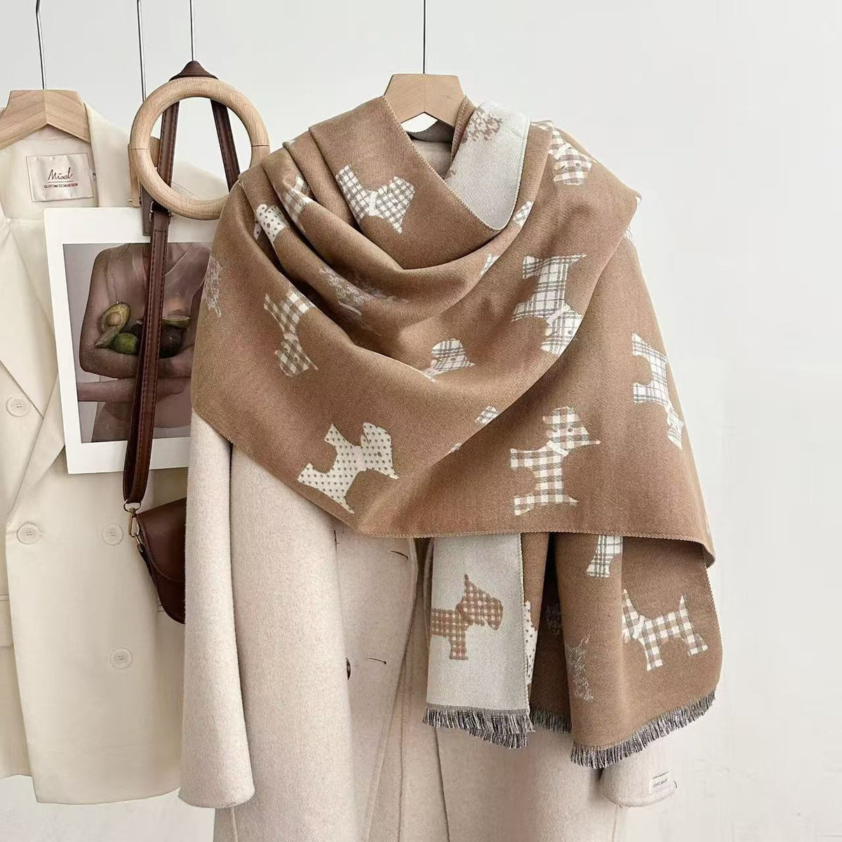Camel dog-print blanket scarf with a contrasting reverse and fringed ends, draped over a coat