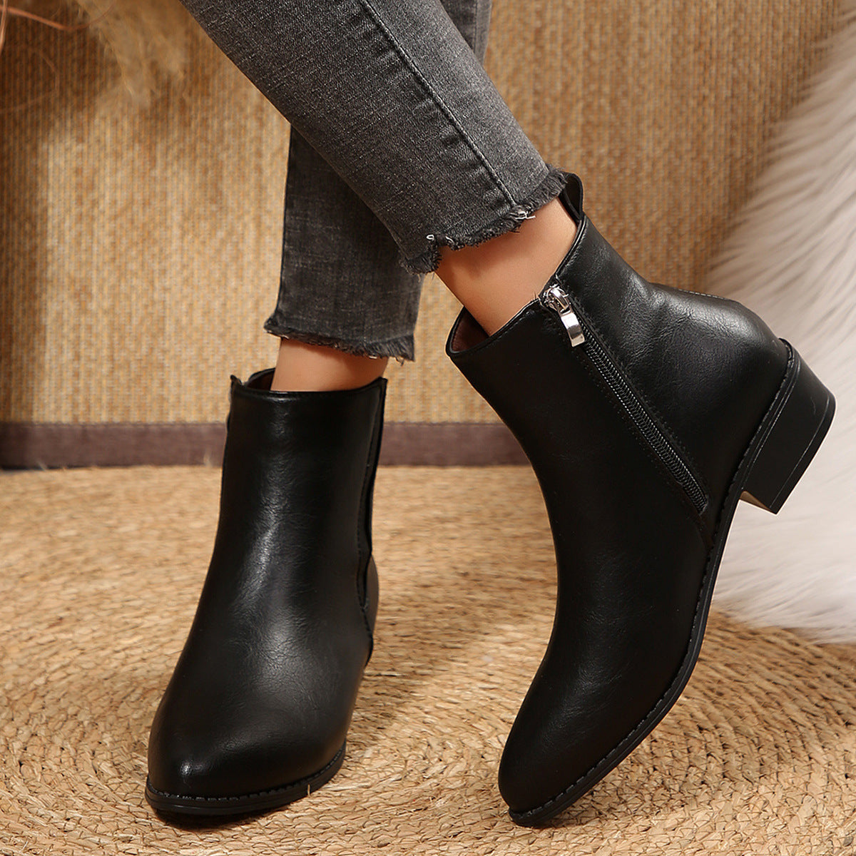 Black pointed-toe ankle booties with side zipper and low block heel