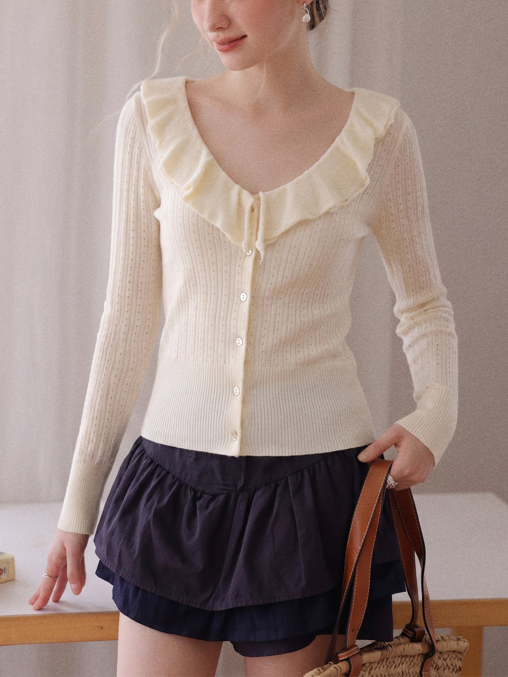 Cream knit cardigan with ruffle V-neck collar, button front, long sleeves