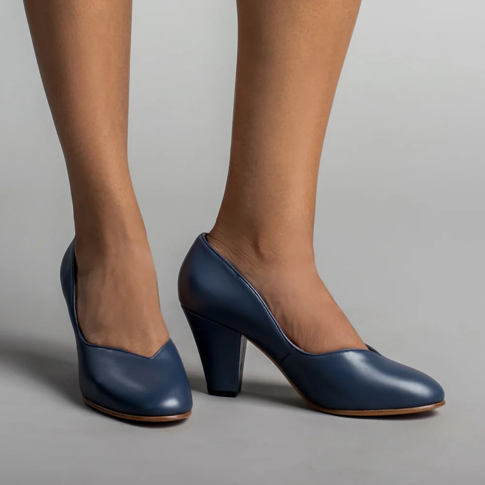 Dark blue leather pumps with closed toes, V-cut openings, and block heels
