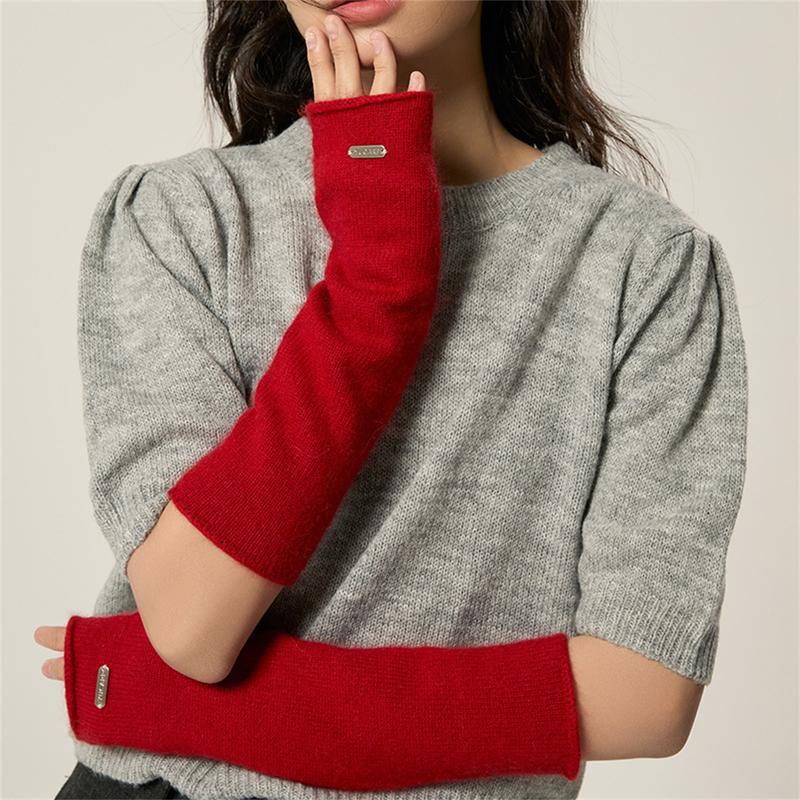 Red fingerless knit arm warmers with thumbhole and stitched label on cuff