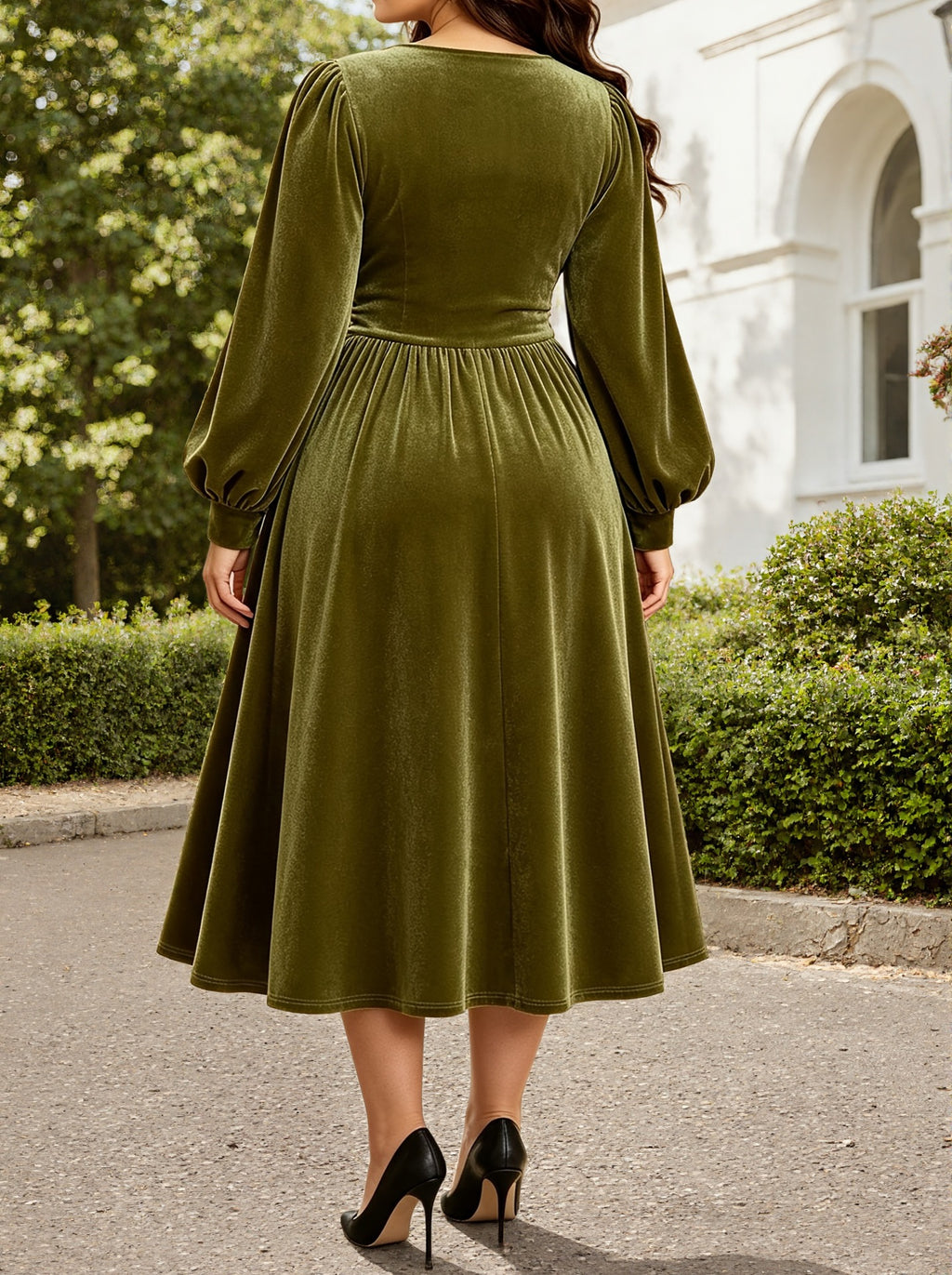 Back view: green velvet midi dress with long sleeves and ruched waist, fit-and-flare