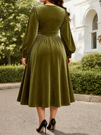 Back view: green velvet midi dress with long sleeves and ruched waist, fit-and-flare